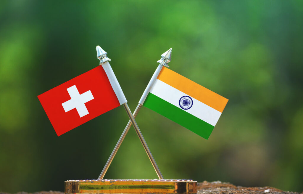 The Swiss Connection: Why Switzerland’s Biggest Companies Are Building Their Future in India India,And,Switzerland,Small,Flag,With,Blur,Green,Background